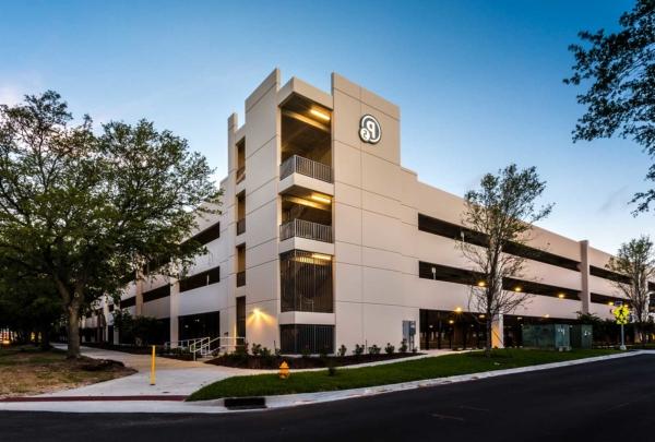 Exterior photo of Baptist parking structure's main corner mid-day.